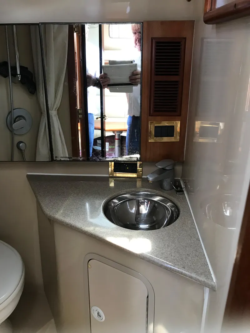 Slide: The Image of 2005 Rampage 30' Express Sportfish bathroom with sink, mirror, and storage. - 24