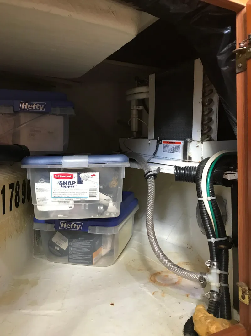 Slide: The Image of Storage area in a 2005 Rampage 30' Express Sportfish boat with organized containers and equipment. - 26