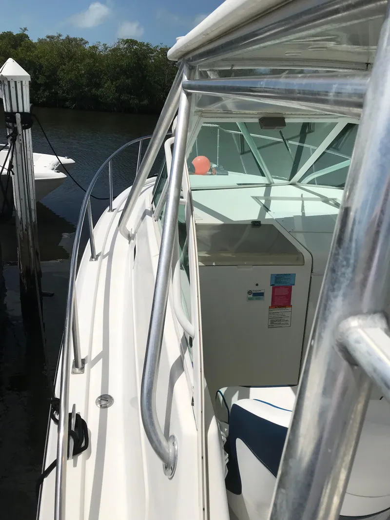 Slide: The Image of 2005 Rampage 30' Express Sportfish docked, showcasing sleek design and sturdy railings. - 27