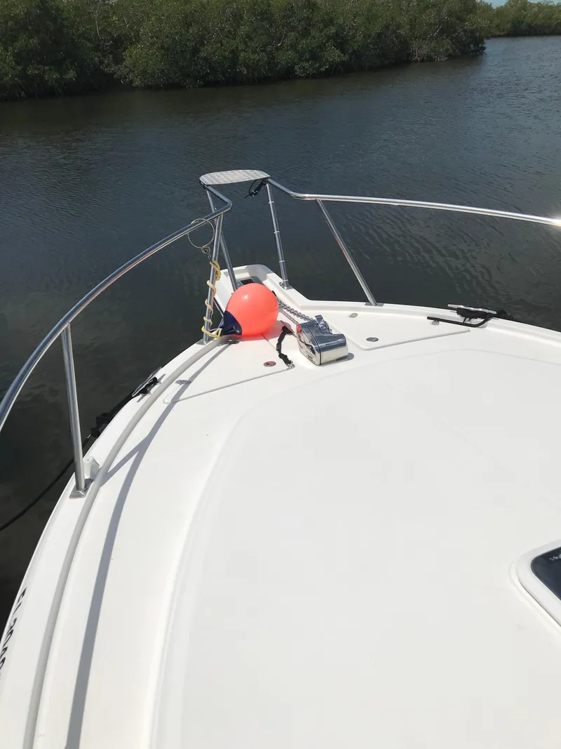 Slide: The Image of 2005 Rampage 30' Express Sportfish boat on calm water, front deck view. - 28