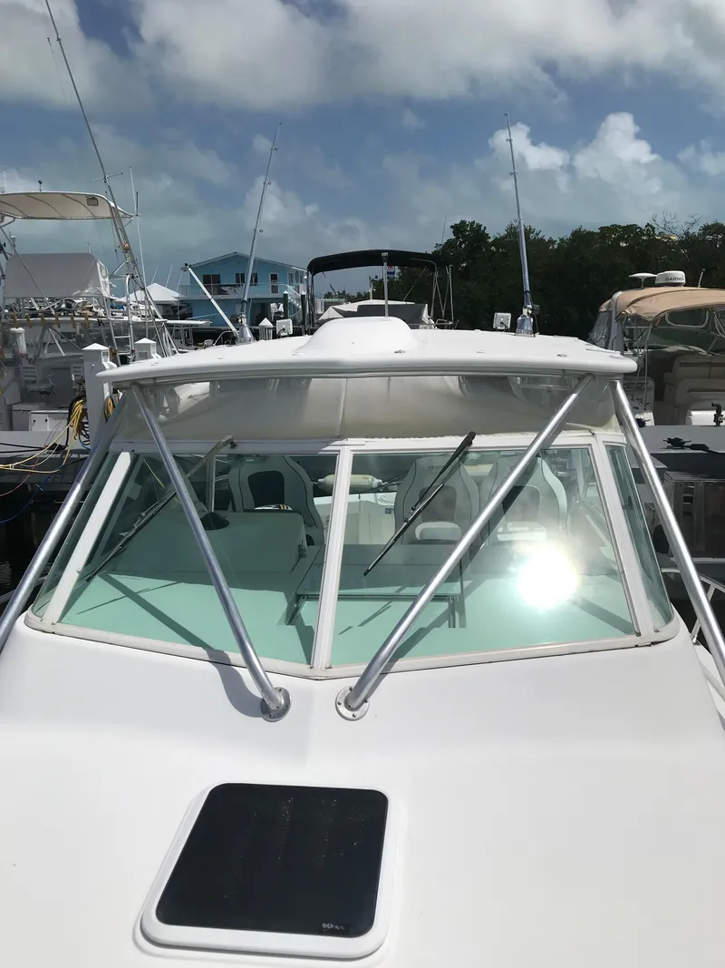 Slide: The Image of 2005 Rampage 30' Express Sportfish boat docked under a partly cloudy sky. - 29