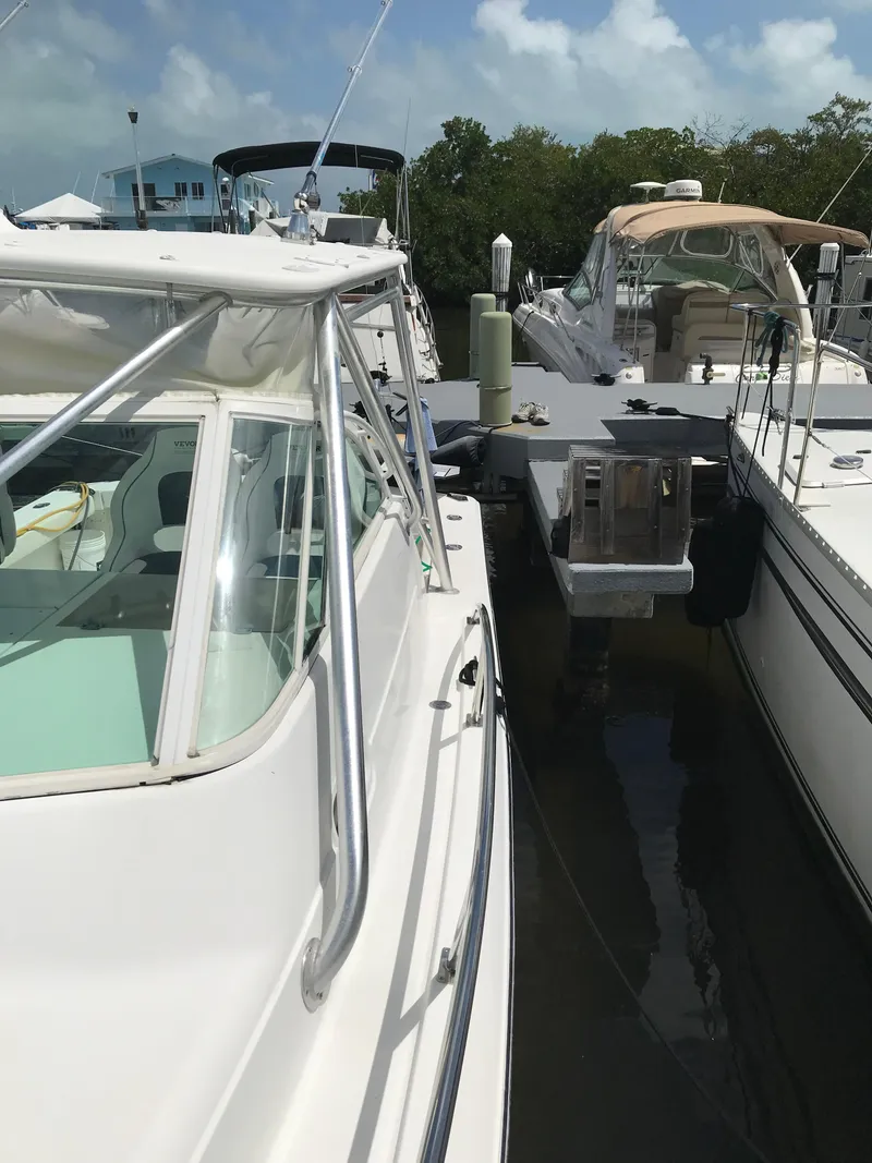 Slide: The Image of 2005 Rampage 30' Express Sportfish docked alongside other boats. - 31