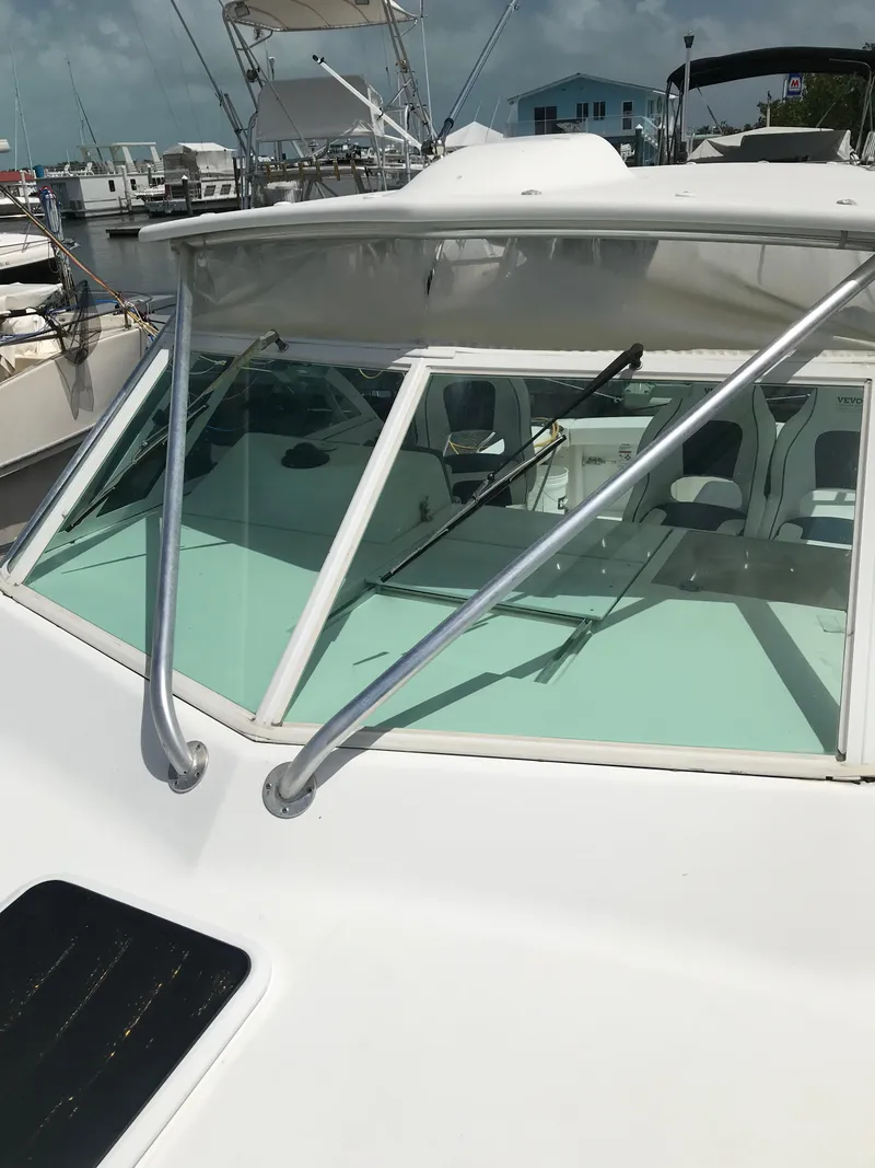 Slide: The Image of 2005 Rampage 30' Express Sportfish boat docked at a marina. - 32