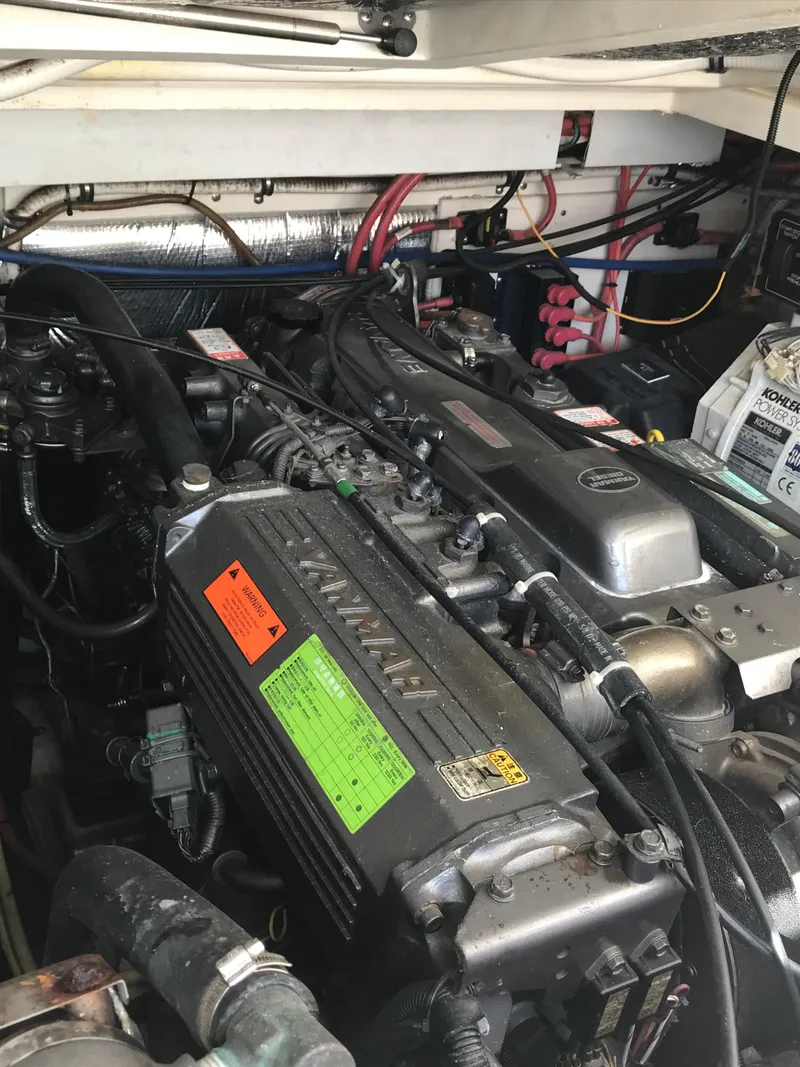 Slide: The Image of Engine compartment of a 2005 Rampage 30' Express Sportfish boat, showcasing detailed machinery. - 39