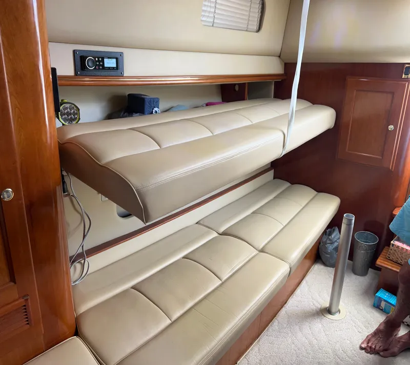 Slide: The Image of 2005 Rampage 30' Express Sportfish interior with beige leather seating and wooden cabinetry. - 44