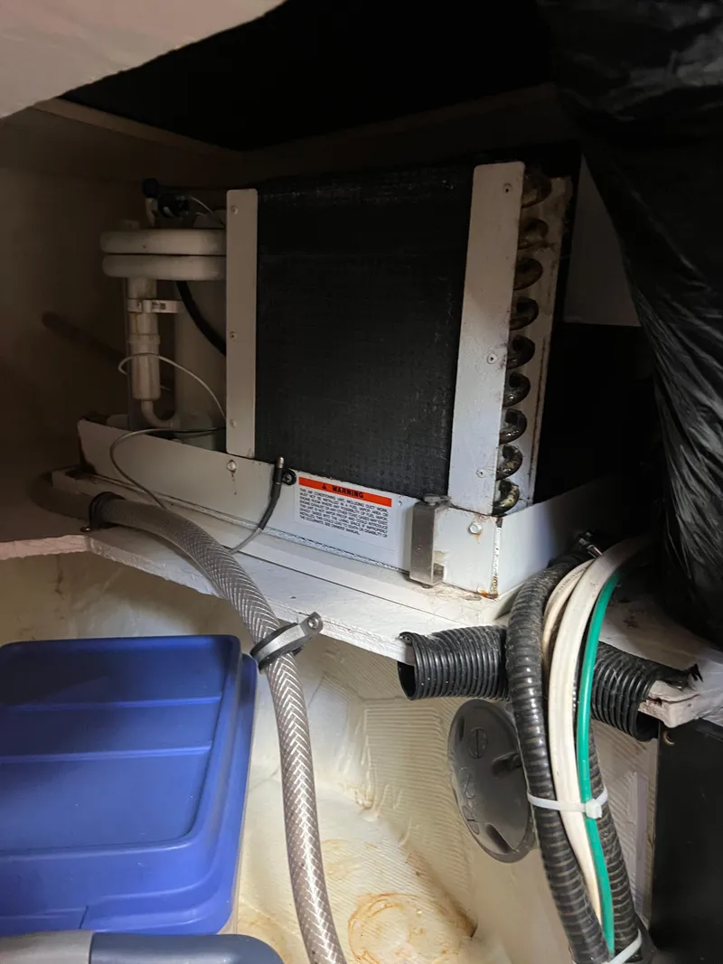 Slide: The Image of 2005 Rampage 30' Express Sportfish engine room with equipment and storage. - 46