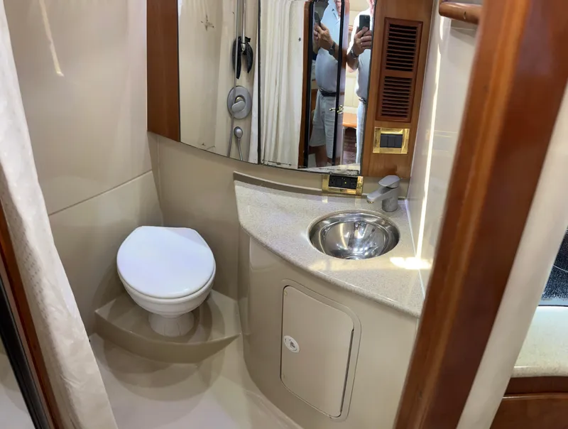Slide: The Image of 2005 Rampage 30' Express Sportfish bathroom with toilet, sink, and mirror. - 47