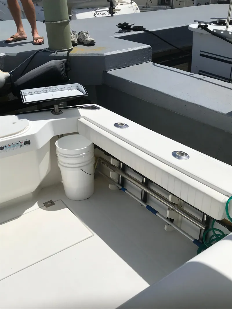 Slide: The Image of 2005 Rampage 30' Express Sportfish boat deck with fishing gear and storage. - 6