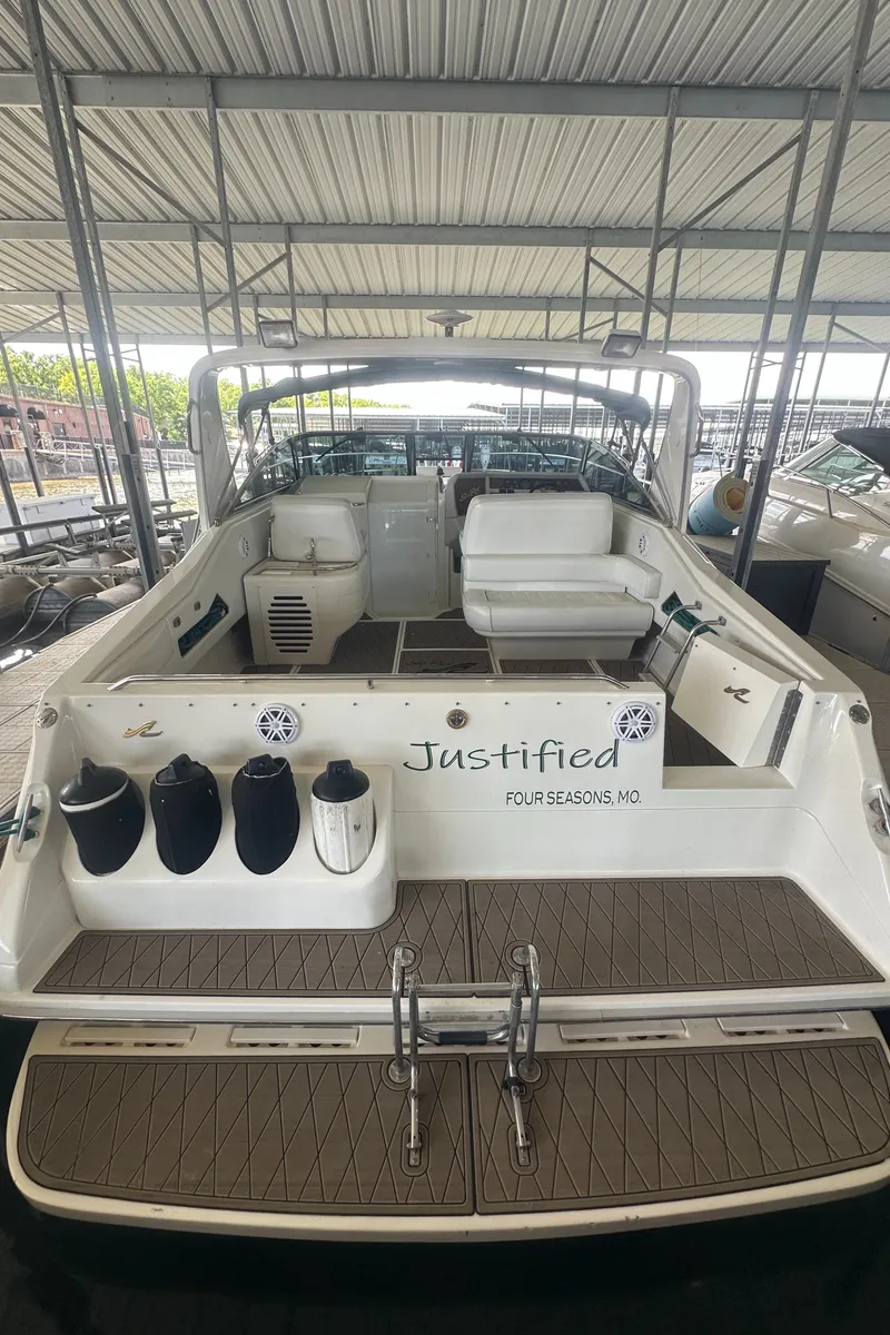 Slide: The Image of 1994 Sea Ray 370 Express Cruiser docked, featuring spacious deck and seating area. - 14