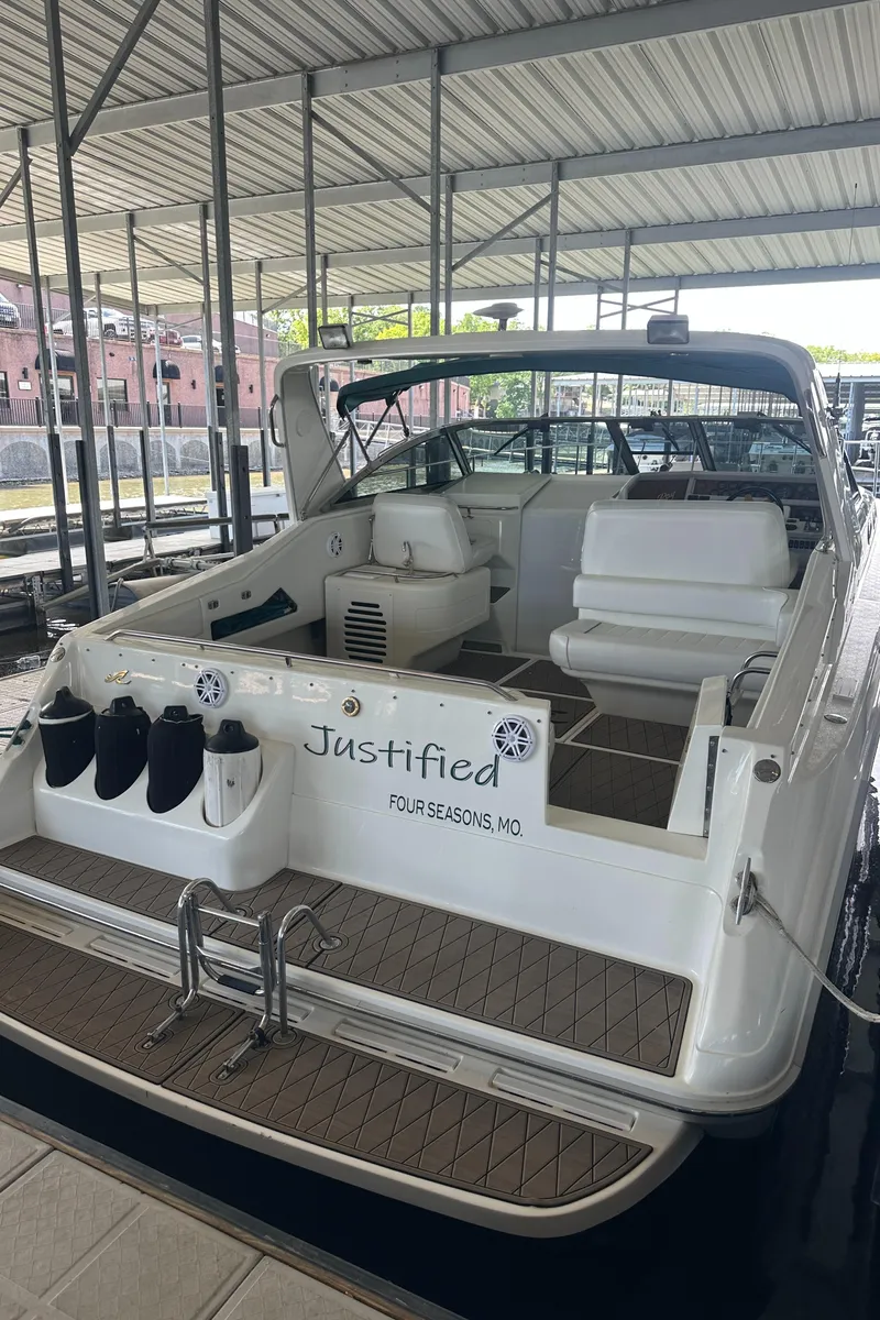 Slide: The Image of 1994 Sea Ray 370 Express Cruiser docked in a covered marina. - 15