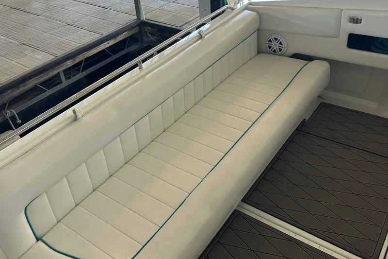 Slide: The Image of 1994 Sea Ray 370 Express Cruiser interior with white cushioned seating. - 18