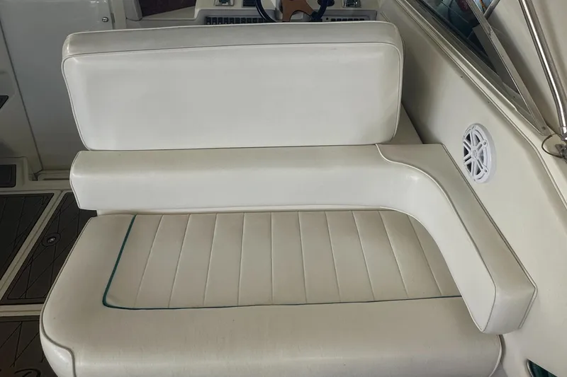 Slide: The Image of White leather seating on a 1994 Sea Ray 370 Express Cruiser boat. - 19