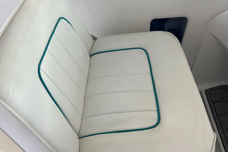Slide: The Image of 1994 Sea Ray 370 Express Cruiser white seat with teal piping detail. - 28