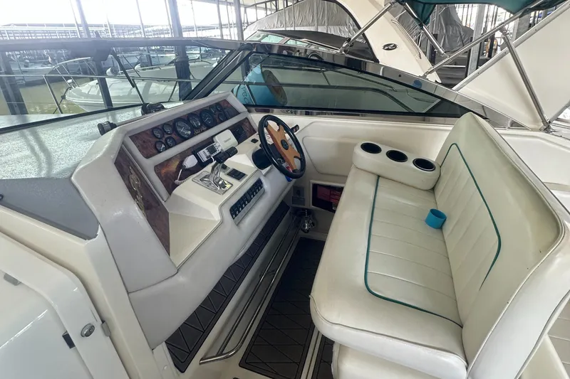 Slide: The Image of 1994 Sea Ray 370 Express Cruiser cockpit with steering wheel and seating area. - 30