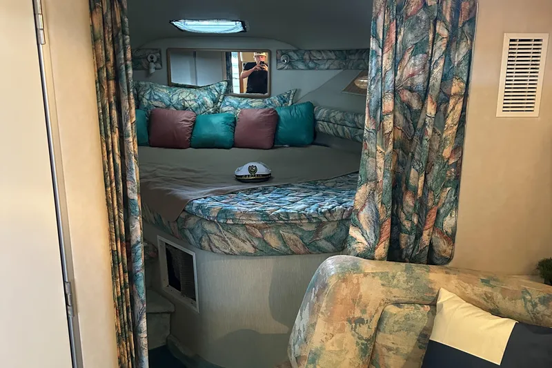 Slide: The Image of 1994 Sea Ray 370 Express Cruiser cabin with cozy bed and patterned decor. - 34