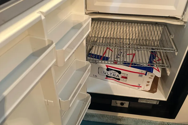 Slide: The Image of Open refrigerator in 1994 Sea Ray 370 Express Cruiser with beverage box inside. - 36