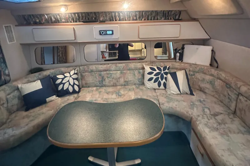 Slide: The Image of 1994 Sea Ray 370 Express Cruiser interior with curved seating and decorative pillows. - 37