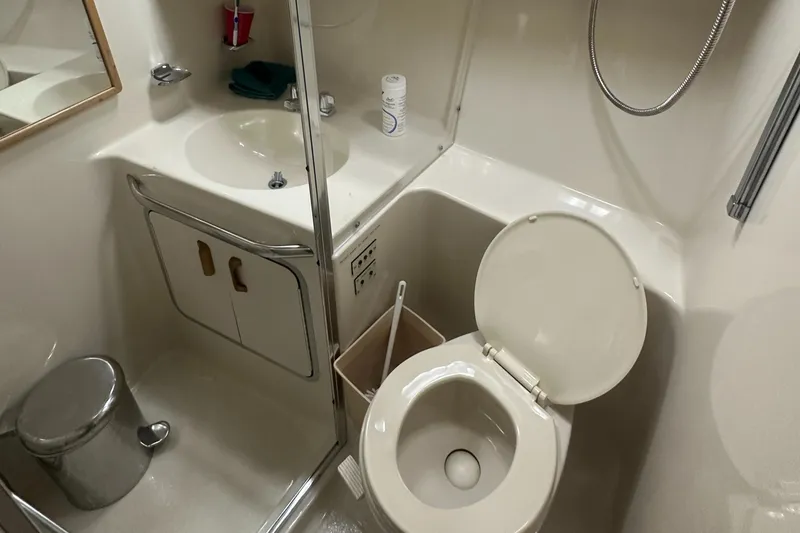 Slide: The Image of Bathroom in 1994 Sea Ray 370 Express Cruiser with toilet, sink, and shower. - 39