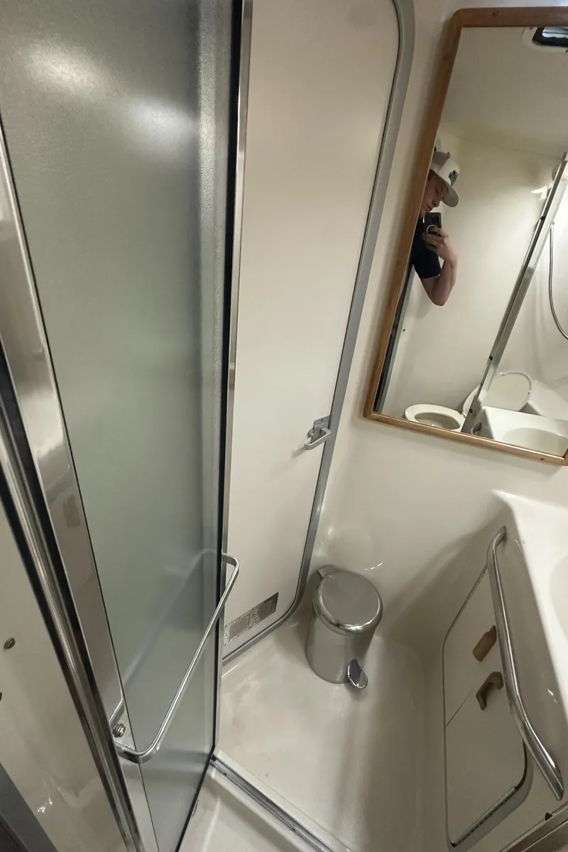 Slide: The Image of Bathroom interior of 1994 Sea Ray 370 Express Cruiser with shower and mirror. - 41