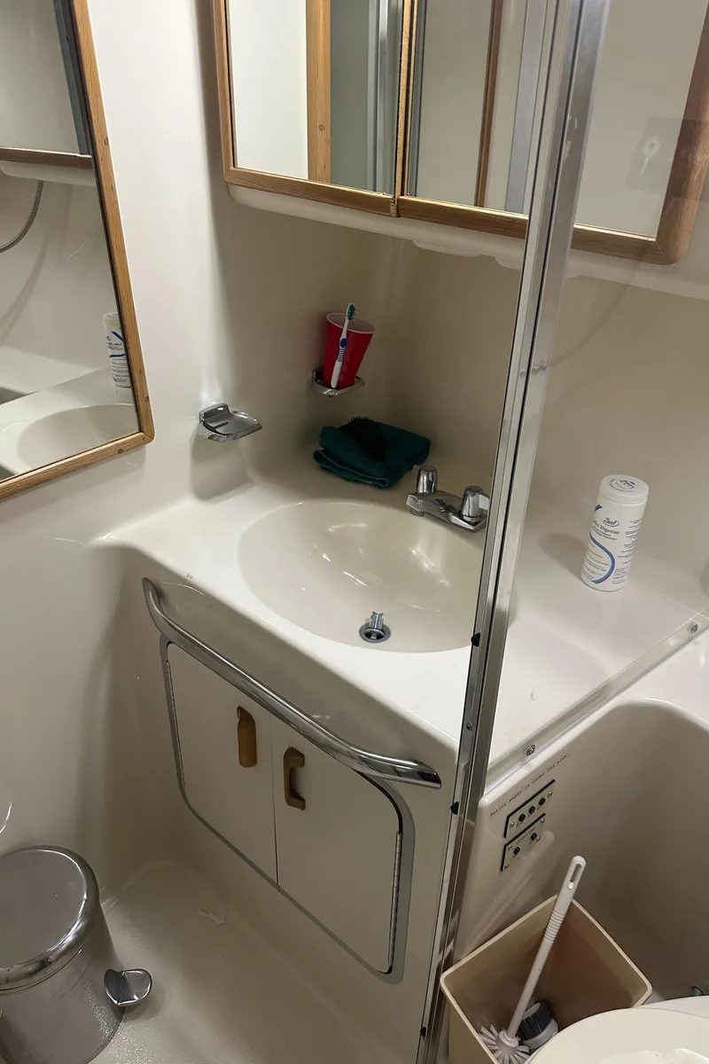 Slide: The Image of Bathroom interior of 1994 Sea Ray 370 Express Cruiser with sink and mirror. - 42