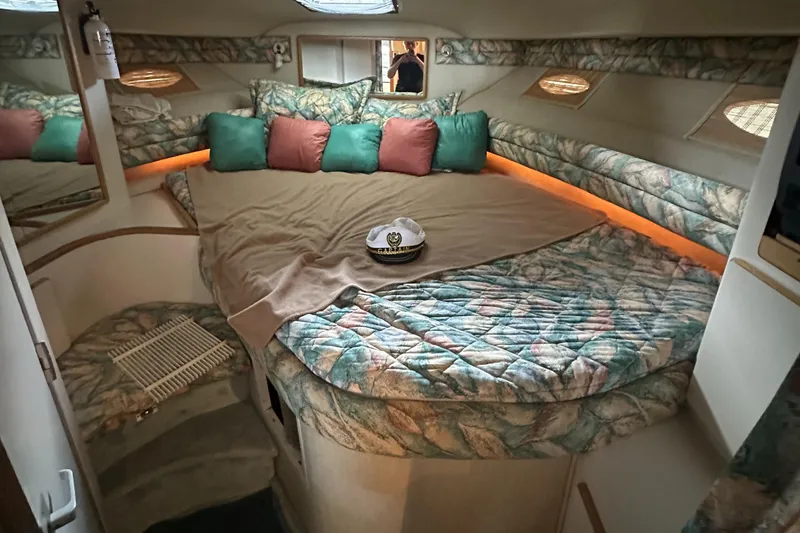 Slide: The Image of 1994 Sea Ray 370 Express Cruiser cabin with cozy bed and decorative pillows. - 46