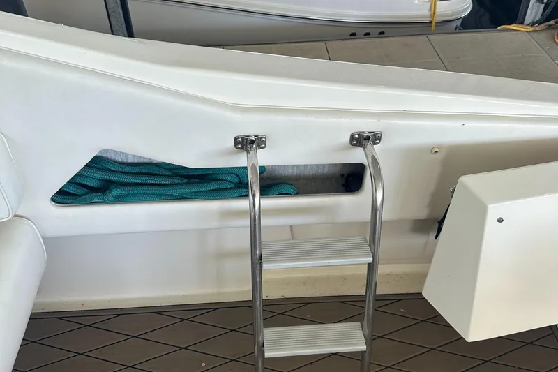 Slide: The Image of 1994 Sea Ray 370 Express Cruiser with stainless steel ladder and storage compartment. - 48