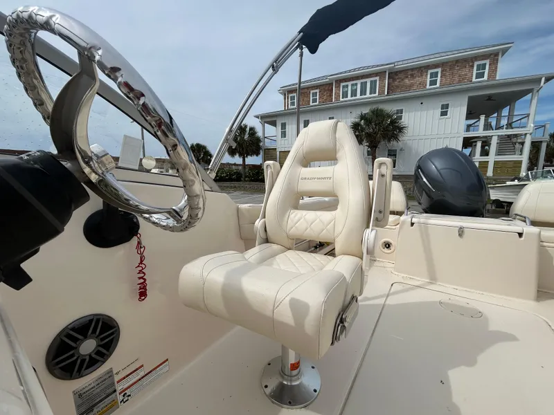 Slide: The Image of 2022 Grady-White Freedom 215 boat interior with steering wheel and captain's chair. - 10