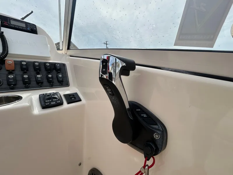 Slide: The Image of 2022 Grady-White Freedom 215 boat control panel with throttle lever and switches. - 13
