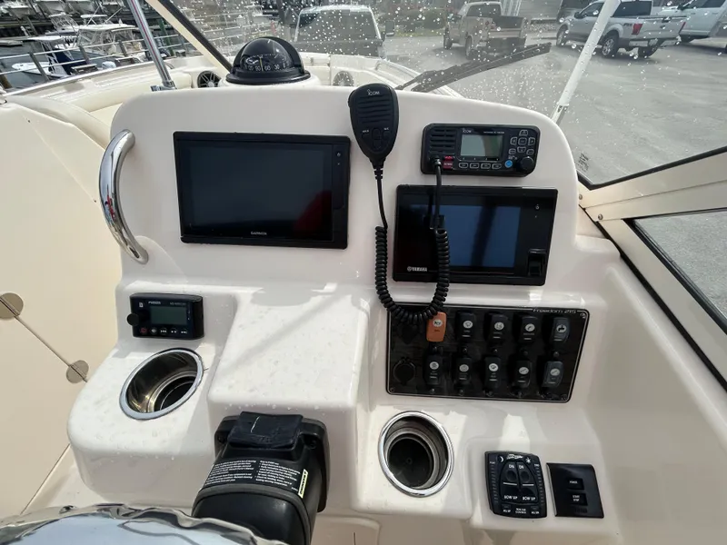 Slide: The Image of Control panel of 2022 Grady-White Freedom 215 boat with navigation screens and radio. - 14