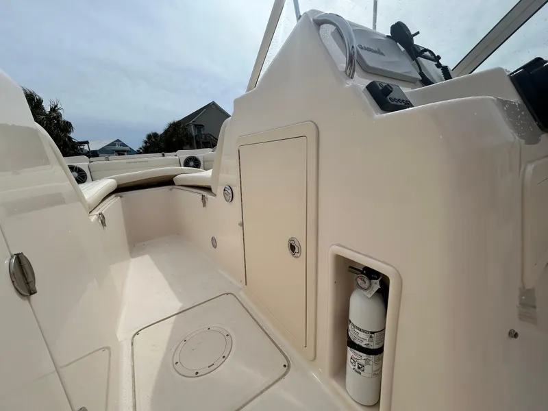 Slide: The Image of 2022 Grady-White Freedom 215 boat interior with storage and fire extinguisher. - 18