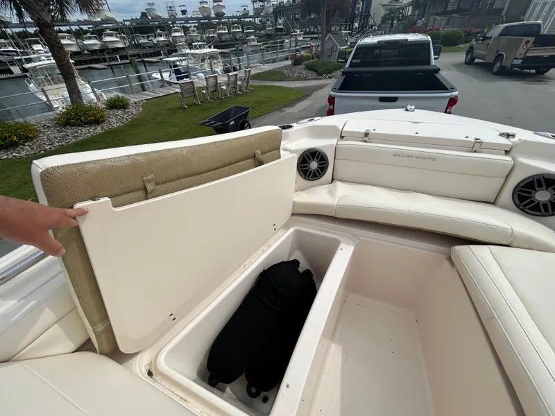 Slide: The Image of 2022 Grady-White Freedom 215 boat with open storage compartment and seating area. - 20