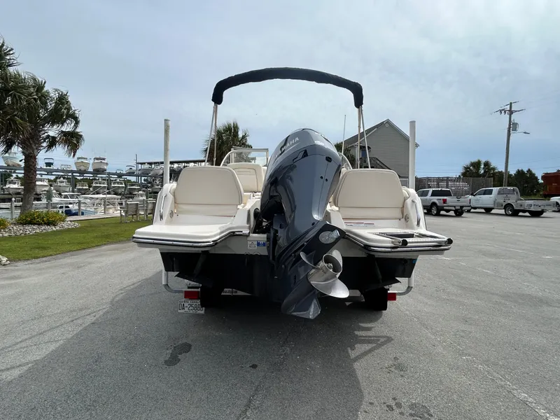 Slide: The Image of 2022 Grady-White Freedom 215 boat with outboard motor, parked in marina lot. - 4
