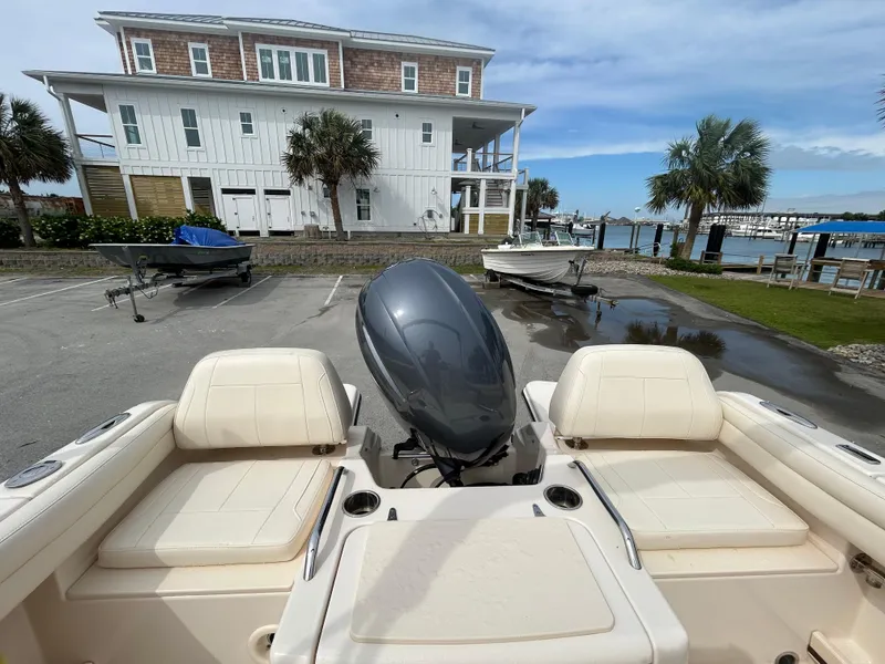 Slide: The Image of 2022 Grady-White Freedom 215 boat parked near waterfront with scenic background. - 7