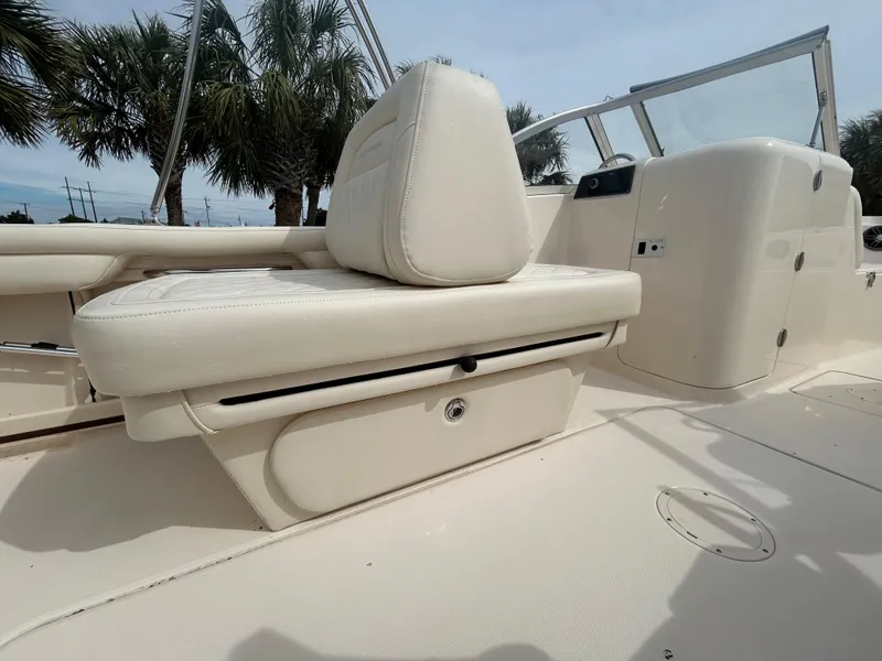 Slide: The Image of 2022 Grady-White Freedom 215 boat interior with white seating and storage compartment. - 9