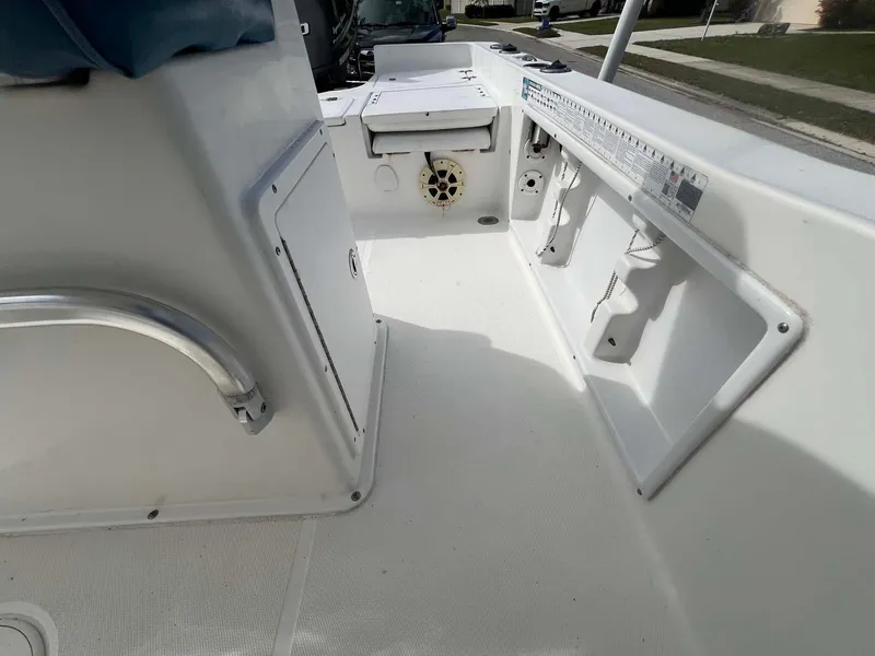 Slide: The Image of 2014 Sea Hunt SXS boat interior with storage compartments and seating. - 10