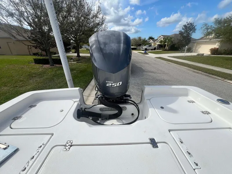 Slide: The Image of 2014 Sea Hunt SXS boat with Yamaha 250 engine on a residential street. - 12