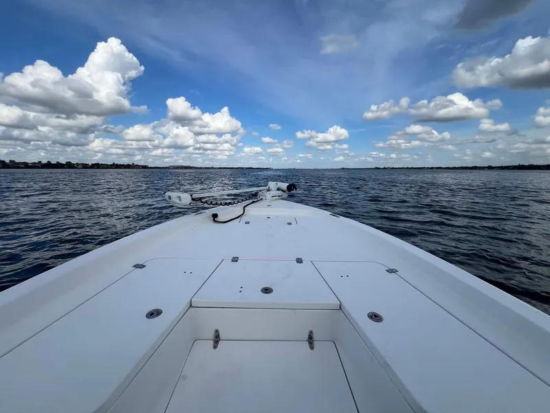 Slide: The Image of Bow view of 2014 Sea Hunt SXS boat on open water under blue sky. - 3