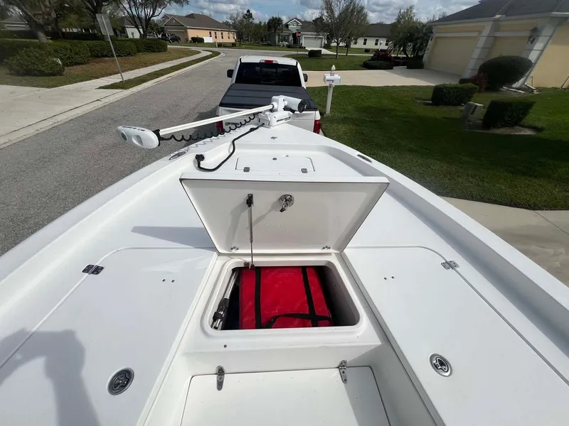 Slide: The Image of 2014 Sea Hunt SXS boat with open storage compartment, parked in residential area. - 4