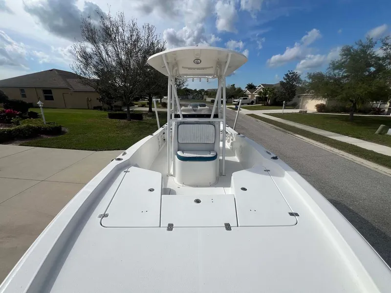 Slide: The Image of 2014 Sea Hunt SXS boat on a residential street under a blue sky. - 5