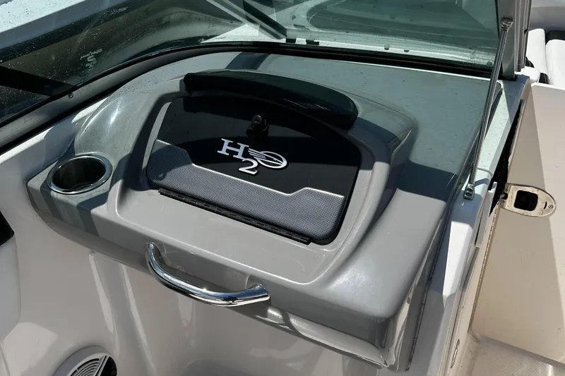 Slide: The Image of 2017 Chaparral 21 H2O Sport OB dashboard with storage compartment and cup holder. - 11