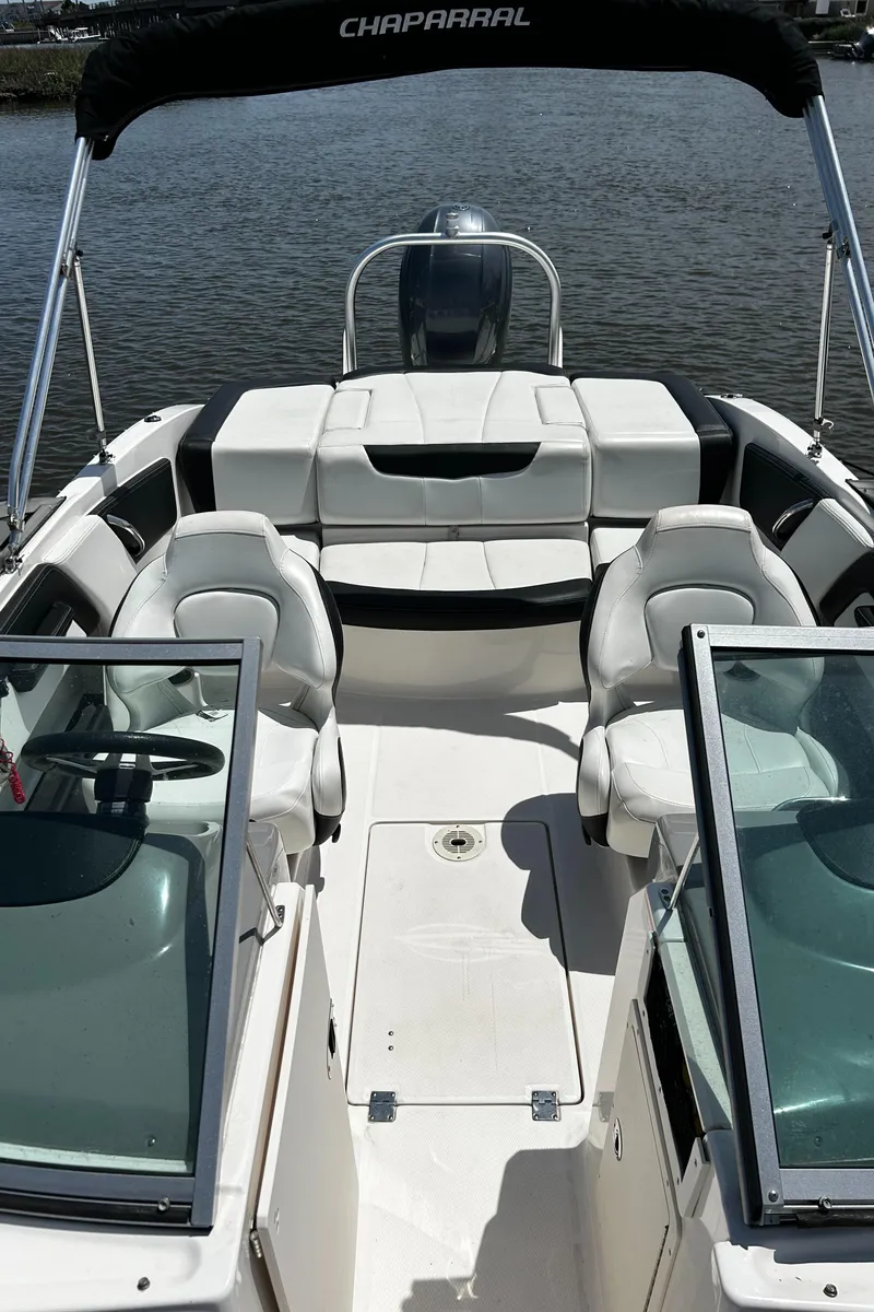 Slide: The Image of 2017 Chaparral 21 H2O Sport OB boat with seating, on calm water. - 14