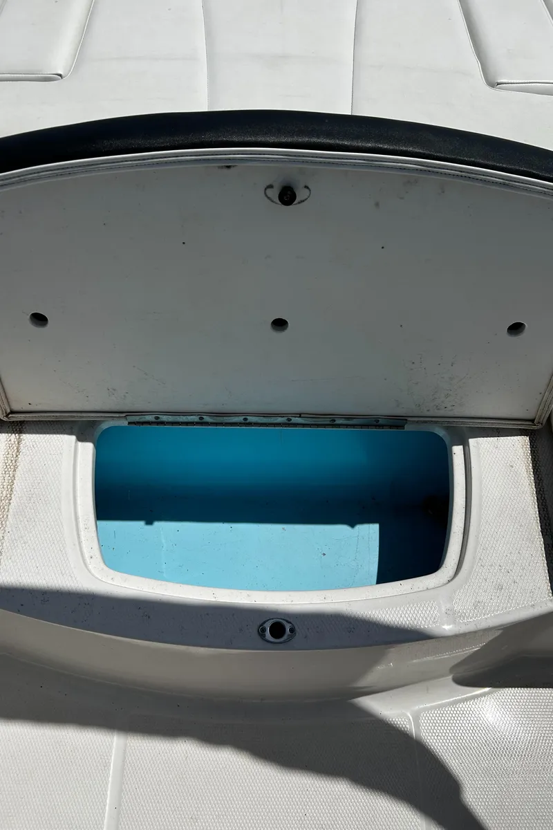 Slide: The Image of 2017 Chaparral 21 H2O Sport OB boat storage compartment open. - 17