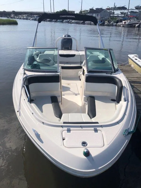 Slide: The Image of 2017 Chaparral 21 H2O Sport OB boat docked on calm water. - 3
