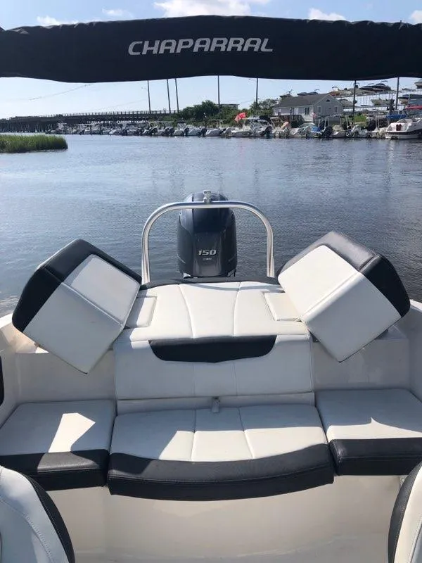 Slide: The Image of 2017 Chaparral 21 H2O Sport OB boat with seating, on a calm waterway. - 4