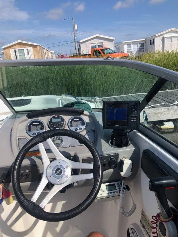 Slide: The Image of 2017 Chaparral 21 H2O Sport OB boat dashboard with steering wheel and navigation system. - 7