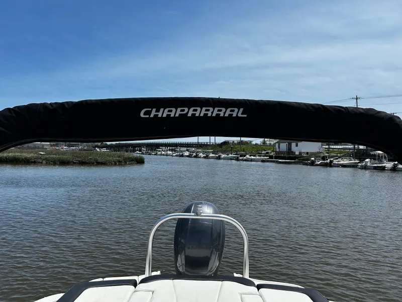 Slide: The Image of Chaparral 21 H2O Sport OB 2017 boat on a calm river under a clear blue sky. - 9