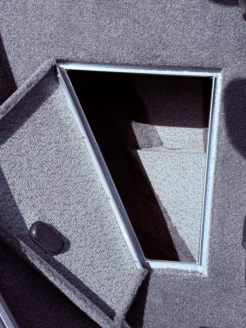 Slide: The Image of Open storage compartment in 2018 Lund 1675 Impact Sport boat. - 13