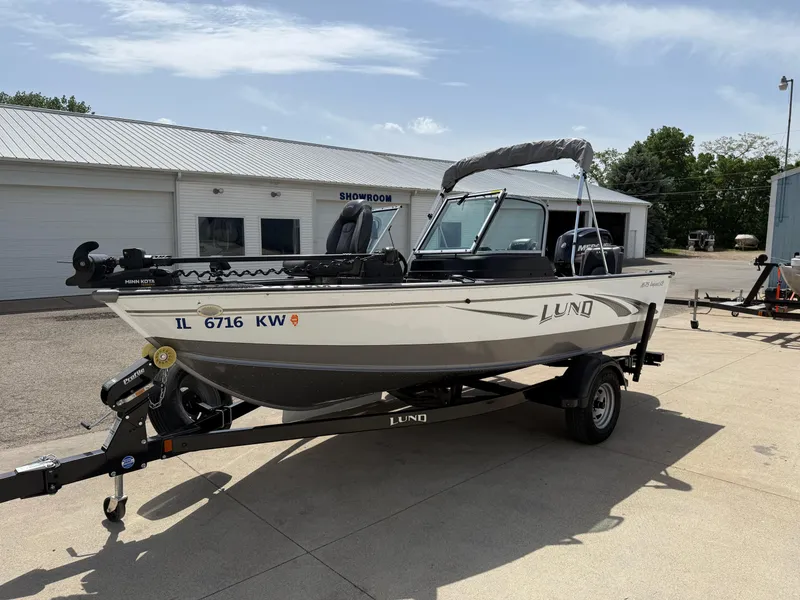 Slide: The Image of 2018 Lund 1675 Impact Sport boat on trailer outside showroom. - 2