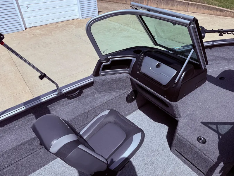 Slide: The Image of 2018 Lund 1675 Impact Sport boat interior with seating and windshield. - 21