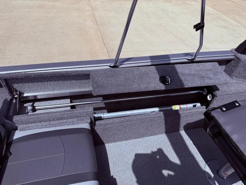 Slide: The Image of 2018 Lund 1675 Impact Sport boat interior with seating and storage compartments. - 24